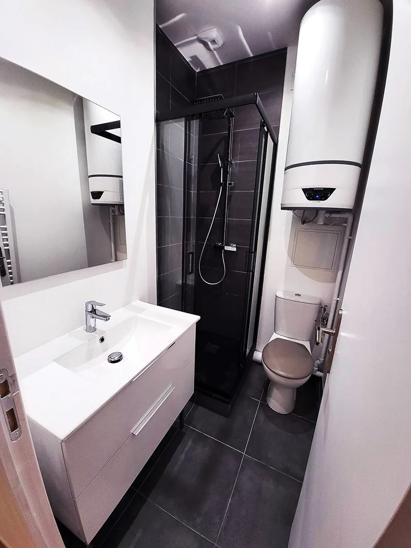Salle de bain rénovée à Paris, équipée d’un chauffe-eau thermodynamique pour une meilleure performance énergétique.